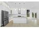 Modern white kitchen featuring a center island, stainless steel appliances, and ample cabinet space at 1650 Eastport Se Ter, Atlanta, GA 30317