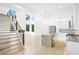 Open-concept living room with modern staircase, and kitchen island, filled with natural light at 1650 Eastport Se Ter, Atlanta, GA 30317