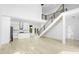 Open concept living room featuring modern staircase, kitchen island and light wood flooring at 1650 Eastport Se Ter, Atlanta, GA 30317