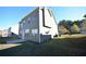 View of the back exterior with siding, windows, and a lawn at 2453 Osceola Rd, Lithonia, GA 30058