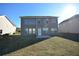 Back exterior of a two-story home with a well-kept yard and a patio area at 2453 Osceola Rd, Lithonia, GA 30058