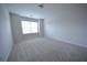 Bedroom with neutral carpeting, a large window for natural light, and neutral wall paint at 2453 Osceola Rd, Lithonia, GA 30058