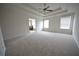 Bright primary bedroom with a ceiling fan, tray ceiling, and an ensuite bathroom at 2453 Osceola Rd, Lithonia, GA 30058