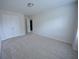 Spacious bedroom with plush carpeting, ample natural light, and a double-door closet at 2453 Osceola Rd, Lithonia, GA 30058