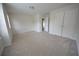 Bedroom with neutral carpet, a window for natural light, and a double door closet at 2453 Osceola Rd, Lithonia, GA 30058