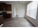 Dining area with wood floor, a three-bulb chandelier, and adjacent kitchen at 2453 Osceola Rd, Lithonia, GA 30058