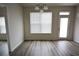 Dining area with wood floor, a three-bulb chandelier, and view to the backyard at 2453 Osceola Rd, Lithonia, GA 30058