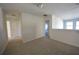 Hallway with neutral carpet, white walls, and doorways leading to various rooms at 2453 Osceola Rd, Lithonia, GA 30058