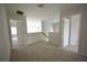 Upstairs hallway with carpet and doorways to other rooms in the house at 2453 Osceola Rd, Lithonia, GA 30058