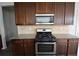 A kitchen with stainless steel oven, granite countertops, and brown cabinets at 2453 Osceola Rd, Lithonia, GA 30058