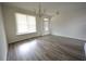 Bright, empty living room with sleek wood-look floors, white walls, and a window at 2453 Osceola Rd, Lithonia, GA 30058