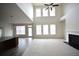 Open-concept living room with a fireplace, high ceilings, and connection to the kitchen at 2453 Osceola Rd, Lithonia, GA 30058