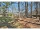 A spacious backyard featuring a fenced perimeter and mature trees at 489 Natasha Dr, Auburn, GA 30011