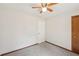 A carpeted bedroom features neutral paint, ceiling fan, and simple trim at 489 Natasha Dr, Auburn, GA 30011