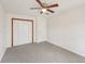 Neutral bedroom featuring a ceiling fan, closet and carpeted flooring at 489 Natasha Dr, Auburn, GA 30011