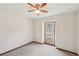 A neutral bedroom has carpet flooring with a window that looks to the neighborhood at 489 Natasha Dr, Auburn, GA 30011