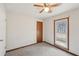 This bedroom features carpet flooring, a ceiling fan, and a window with outdoor view at 489 Natasha Dr, Auburn, GA 30011