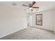 Neutral bedroom featuring a ceiling fan, window and carpeted flooring at 489 Natasha Dr, Auburn, GA 30011