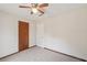 This is a neutral carpeted bedroom with a ceiling fan and a standard closet at 489 Natasha Dr, Auburn, GA 30011