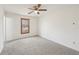 This spacious bedroom features a ceiling fan, carpeted floors, and a large window at 489 Natasha Dr, Auburn, GA 30011