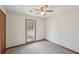 This bedroom features neutral colored walls and carpet with a window view outside at 489 Natasha Dr, Auburn, GA 30011