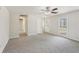 Open living room with neutral carpet, and a hallway leading to other rooms at 489 Natasha Dr, Auburn, GA 30011