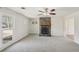 Cozy living room featuring a stone fireplace, a ceiling fan, and a large window at 489 Natasha Dr, Auburn, GA 30011