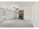 Comfortable living room with a stone fireplace, ceiling fan, and a bright window at 489 Natasha Dr, Auburn, GA 30011