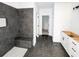 Modern bathroom featuring a gray tiled shower, black bench, and white cabinets, offering a luxurious space at 1269 Pj East Rd, Covington, GA 30014