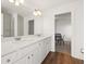 Bathroom with double vanity, quartz countertop, and hardwood flooring, showcasing modern design at 1269 Pj East Rd, Covington, GA 30014