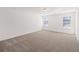 Spacious bedroom with neutral colored carpeting and abundant light at 1269 Pj East Rd, Covington, GA 30014