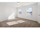 Sun-drenched bedroom with neutral walls, plush carpet, and ample natural light from two large windows at 1269 Pj East Rd, Covington, GA 30014