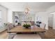 Open-concept dining room with wood table, stylish light fixture, and seamless flow to living area at 1269 Pj East Rd, Covington, GA 30014