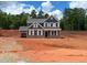 Charming new construction home features a two-story design with a gray exterior, white trim, and an attached garage at 1269 Pj East Rd, Covington, GA 30014