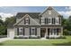 Charming new construction home with neutral siding, dark shutters, stone accents, and a well-manicured lawn at 1269 Pj East Rd, Covington, GA 30014