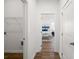 Hallway view with wood floors and doorway leading to bedroom with decor and natural light at 1269 Pj East Rd, Covington, GA 30014