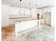 Spacious kitchen featuring white cabinets, center island, pantry, and modern vent hood, ready for appliances at 1269 Pj East Rd, Covington, GA 30014