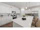 Bright kitchen featuring white cabinets, stainless steel appliances, and a large quartz countertop island at 1269 Pj East Rd, Covington, GA 30014