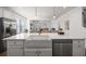 White farmhouse sink and stainless steel dishwasher in the kitchen, with pendant lighting above the island at 1269 Pj East Rd, Covington, GA 30014