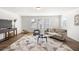 Sunlit living room boasts hardwood floors, a modern sofa, and an inviting atmosphere for relaxation and entertainment at 1269 Pj East Rd, Covington, GA 30014