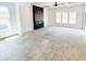 Bright living room with black fireplace, tray ceiling, and large windows allowing natural light to fill the space at 1269 Pj East Rd, Covington, GA 30014