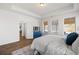 A primary bedroom featuring wood floors, tray ceilings, and an exterior patio area at 1269 Pj East Rd, Covington, GA 30014