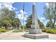 Memorial monument in a park-like setting featuring an American flag, mature trees, and landscaped grounds at 1269 Pj East Rd, Covington, GA 30014