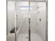 Modern bathroom shower featuring white marble tiling and a built-in bench for enhanced comfort at 1269 Pj East Rd, Covington, GA 30014