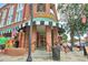 Inviting brick building featuring Scoops with a black and white striped awning, American flags, and outdoor seating at 1269 Pj East Rd, Covington, GA 30014