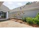 Backyard area showing patio and gray siding with landscaping features at 134 Rose Cottage Ln, Woodstock, GA 30189