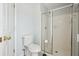 Bright bathroom featuring a glass-enclosed shower and white tiled walls at 134 Rose Cottage Ln, Woodstock, GA 30189