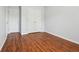 Bedroom with wood-look floors, two closets, and neutral paint at 134 Rose Cottage Ln, Woodstock, GA 30189