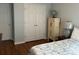 Bright bedroom with wood-look floors, closet and stylish cabinet at 134 Rose Cottage Ln, Woodstock, GA 30189