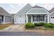 Charming, light-green, single-story home featuring a well-manicured yard and attached one-car garage at 134 Rose Cottage Ln, Woodstock, GA 30189